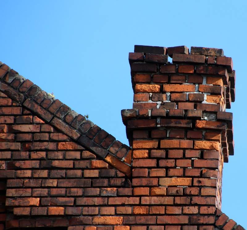 Signs Your Dundalk Home Needs a Chimney Inspection Damaged chimney on an Dundalk home showing cracks and missing mortar